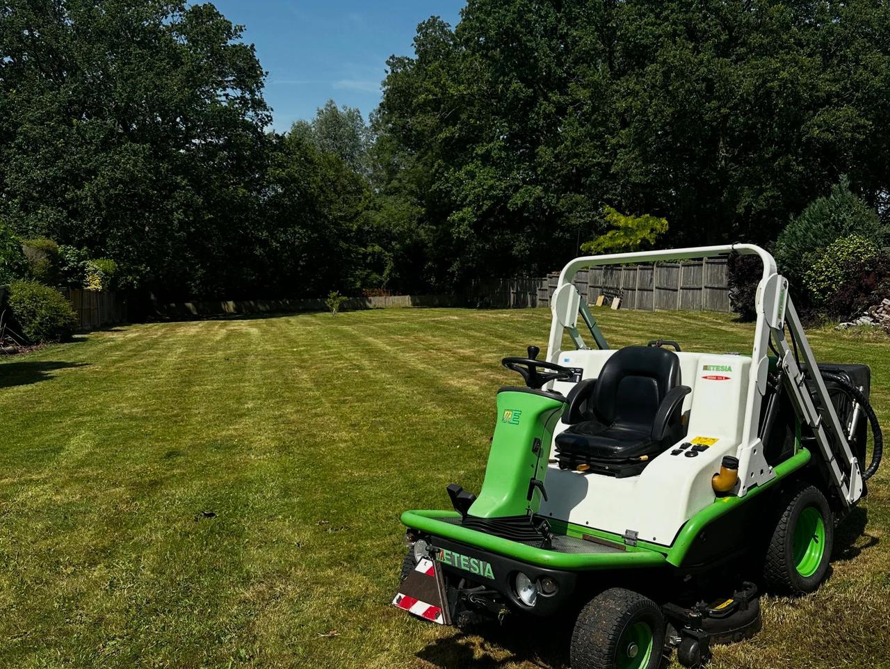 Ride-on mower cutting a large lawn